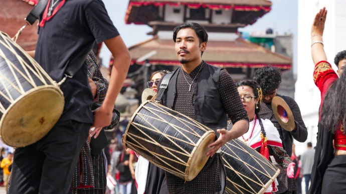 Musicians playing traditional drums in a festival.